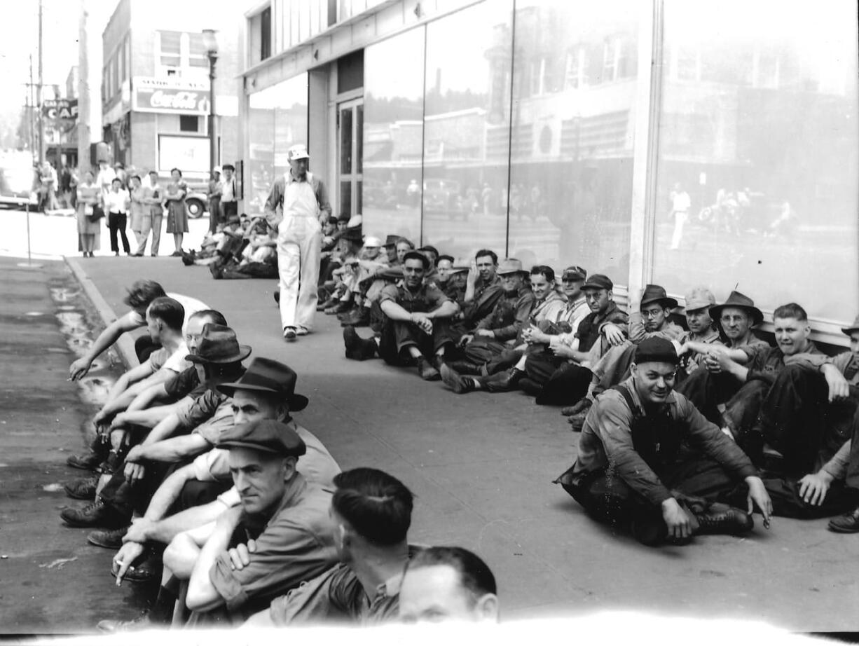 Crown Zellerbach paper mill workers wait to start their shift sometime during the 1940s. The Coca-Cola sign in the background is attached to the building that now houses the Mill Corner Tavern at Northeast Fourth and Adams Street. The building the employees are sitting in front of no longer exists. Columbia River Paper Co. was incorporated in 1884 by Henry L. Pittock, publisher of The Oregonian.