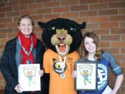 Taylor Grasseth (right), an eighth-grader from Jemtegaard Middle School, poses with her art teacher, Gabrielle Iverson, and the WSF Stride Cat.