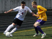 Camas forward Cayne Cardwell keeps the soccer ball alive for the Papermakers in the far right corner at Doc Harris Stadium.