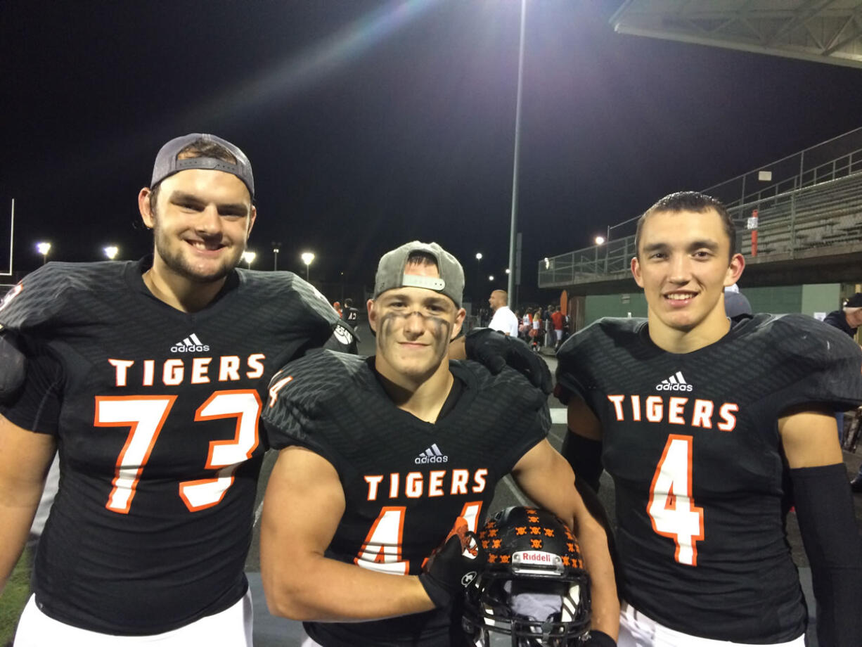 Battle Ground defenders Brady Brick (73), Kolton Lehto (44) and Landon Hall (4)