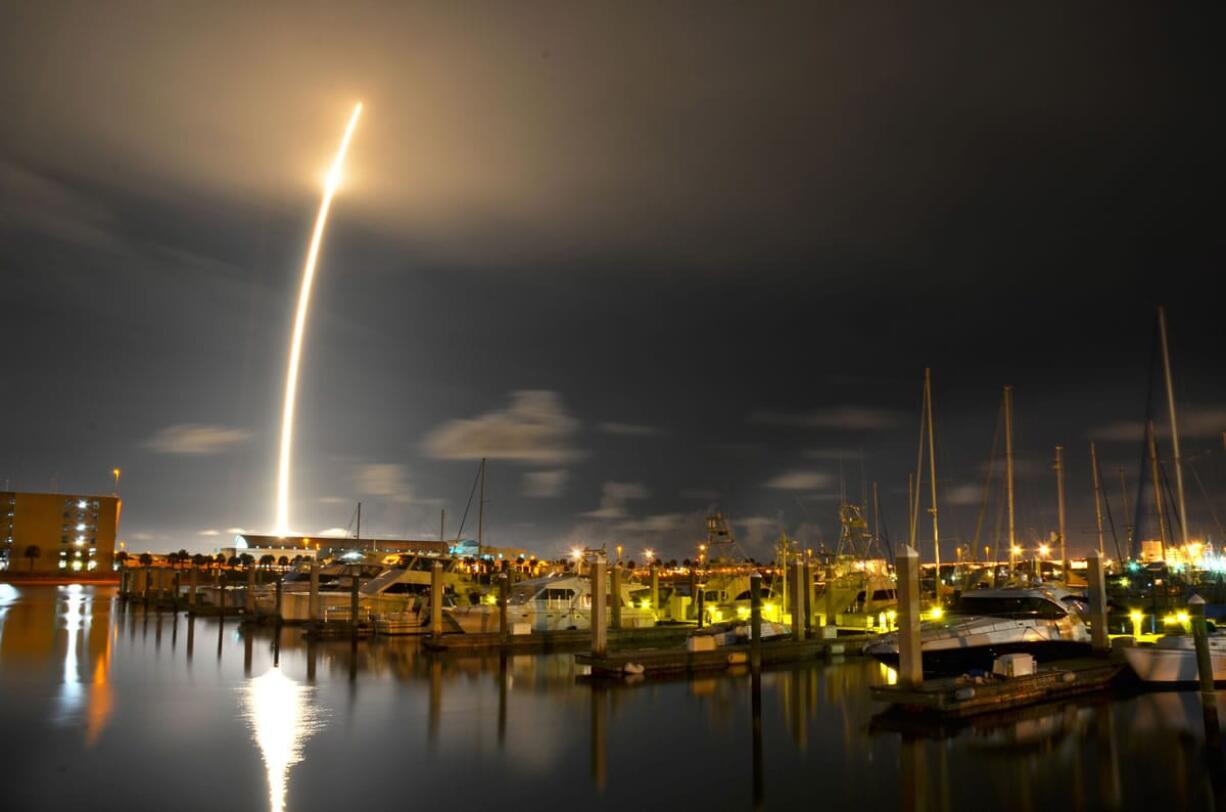 A 71-second exposure from Port Canaveral, Fla., captures the SpaceX Falcon 9 rocket lifting off from the Cape Canaveral Air Force Station on Oct. 7, 2012. Seattle-based Spaceflight has booked a Falcon 9 rocket launch in 2017.