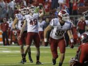 Washington kicker State Erik Powell (46) celebrates his point after kick during an NCAA college football game against Rutgers Saturday, Sept. 12, 2015, in Piscataway, N.J.