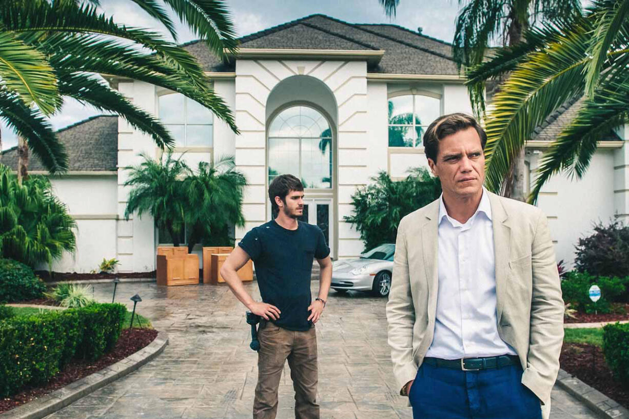 Andrew Garfield, left, stars as Dennis Nash with Michael Shannon as Rick Carver in &quot;99 Homes.&quot; (Hooman Bahrani/Broad Green Pictures)