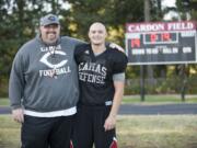 Camas High School player Trevor Wochnick and his dad Justin Wochnick posed at Camas practice on Wednesday.