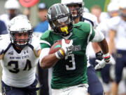 Portland State running back David Jones breaks through the Montana State defense for some of his 285 yards rushing on Saturday. Jones scored two touchdowns in the Vikings&#039; 59-42 win.