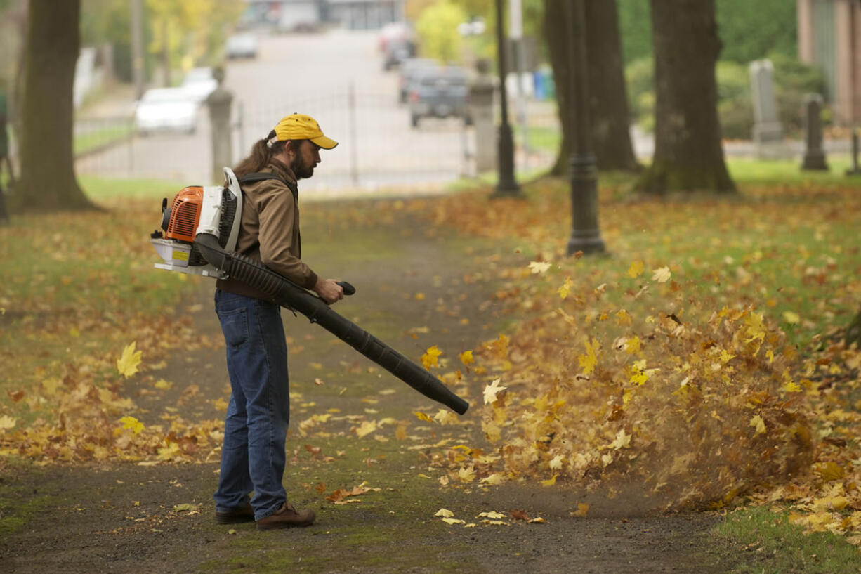 Kermit Siegle volunteers his time clearing leaves at the Old City Cemetery as part of Make a Difference Day in 2013.