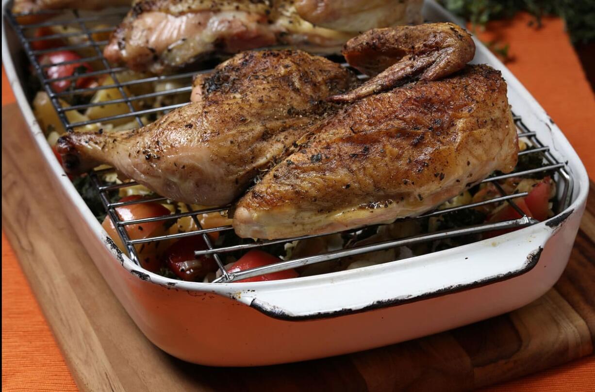 The chicken halves roast on a rack over the vegetables, ensuring crisp skin for the bird, and deeper flavor for the vegetables as the juices drip into them. (E.