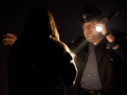 WSP Trooper Ben Taylor administers a field sobriety test to a driver who nearly crashed her car into a concrete barrier on state Highway 500 in December 2011. The driver was arrested on suspicion of DUI.