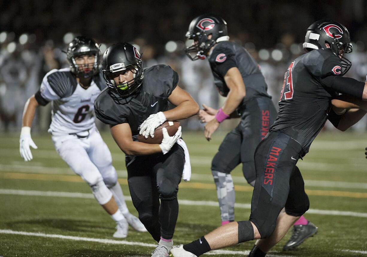 Camas&#039; Jordan Del Moral, center, scrambles past Union defenders to score during the Papermakers&#039; win at Doc Harris Stadium in Camas.