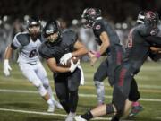 Camas&#039; Jordan Del Moral, center, scrambles past Union defenders to score during the Papermakers&#039; win at Doc Harris Stadium in Camas.