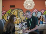 Jaci Cannon of Vancouver, left, shops at Main Street Marijuana with help from Neil McCauley on Monday afternoon. Cannon said she would consider shopping for marijuana in Oregon if it was convenient.