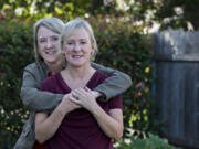 Mary Sullivan, in jacket, and her twin sister, Meg Perlick, both of Vancouver, are both breast cancers survivors who have gone on to lead healthy, active lives.