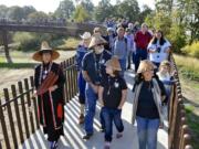 Cowlitz spiritual leader Tanna Engdahl, left, and Chinook vice chairman Sam Robinson -- with granddaughter Destiny and wife Mildred -- have the honor of being first across the new universal-access bridge that now spans the railroad tracks at the Ridgefield National Wildlife Refuge&#039;s northern Carty Unit.