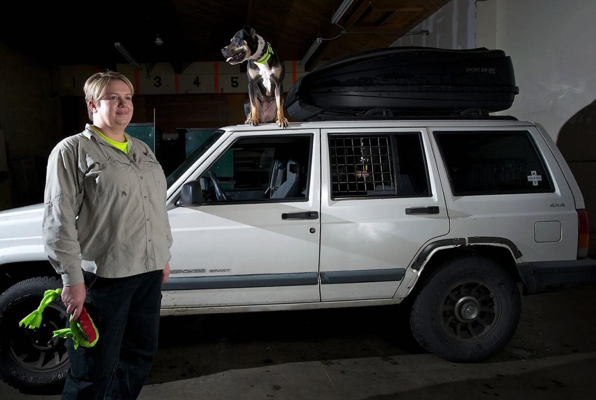 Clark County search and rescue volunteer Victoria Armstrong and her search dog Relic pose for a portrait.