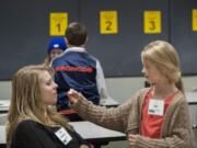 Julie Halvorson, left, closes her eyes as she attempts to guess the vegetable fed to her by her daughter, Kami, 10, during a FoodMania class Wednesday evening at CASEE in Brush Prairie. The vegetable tasting event -- the mystery veggie was a radish -- was one of several activities the children and parents participated in during the two-hour class.