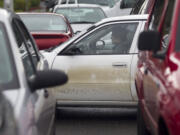 Drivers circle around a parking lot looking for available spaces at Clark College on Monday, the first day of winter quarter.