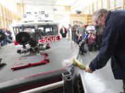 Bruce Firstenburg christens Clark County Fire &amp; Rescue's new boat during a ceremony at the Ridgefield Marina on Friday.