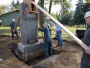 Workers relocate a monument to shipwrecked Japanese sailors Tuesday near the Fort Vancouver National Historic Site&#039;s visitor center. A time capsule was uncovered at the base of the monument on Monday. Foreman Mark Ross, center with level, of SE Services checks to see if the monument is level while working with Justin Neuberger of SE Services, left, Tony Graham of SEH America, and Joe Adams, right, of SE Services.