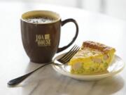 A cup of Anniversary Blend coffee and a slice of ham and broccoli quiche are offered at the Java House in Vancouver.