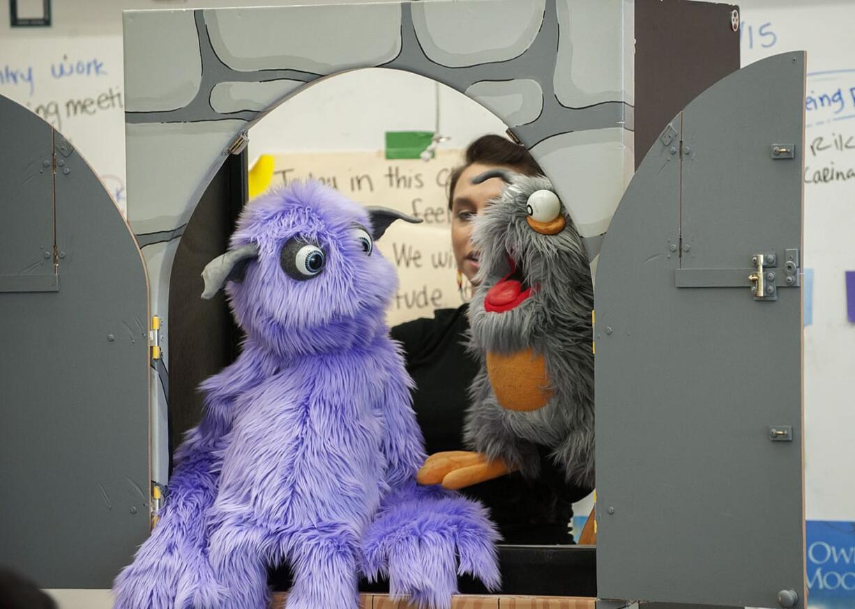 Actor Tricia Castañeda-Gonzales provides the voices for Count Plaqula, left, and Braces the Bat during a presentation of &quot;The Adventures of the Tartar Patrol&quot; on Tuesday afternoon at Sarah J. Anderson Elementary School in Vancouver. The puppets taught a class of third-graders about the importance of brushing and flossing their teeth.