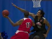 Vancouver Volcanoes center Gjio Bain (R) defends against Portland Chinooks forward Kevin Ford (L).