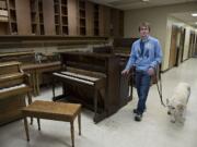 Blake Hardin of Vancouver walks through the Emil Fries School of Piano Tuning and Technology with his dog, Beethoven, 10, after the pair were reunited Monday afternoon, Oct. 19, 2015.