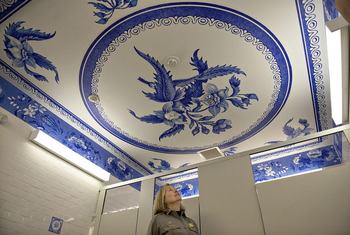 Tracy Fortmann, superintendent for the Fort Vancouver National Historic Site, checks out the new Spode plate pattern on the ceiling of the women&#039;s restroom at the visitor center Wednesday afternoon.