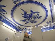 Tracy Fortmann, superintendent for the Fort Vancouver National Historic Site, checks out the new Spode plate pattern on the ceiling of the women&#039;s restroom at the visitor center Wednesday afternoon.