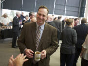 Clark County Commissioner Steve Stuart, bearing his unwashed coffee cup, greets well-wishers at a farewell open house in his honor Thursday.