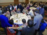 Guests pray over Clark County Sheriff Chuck Atkins and some of his deputies during the prayer breakfast, which recognized community leaders and first responders.