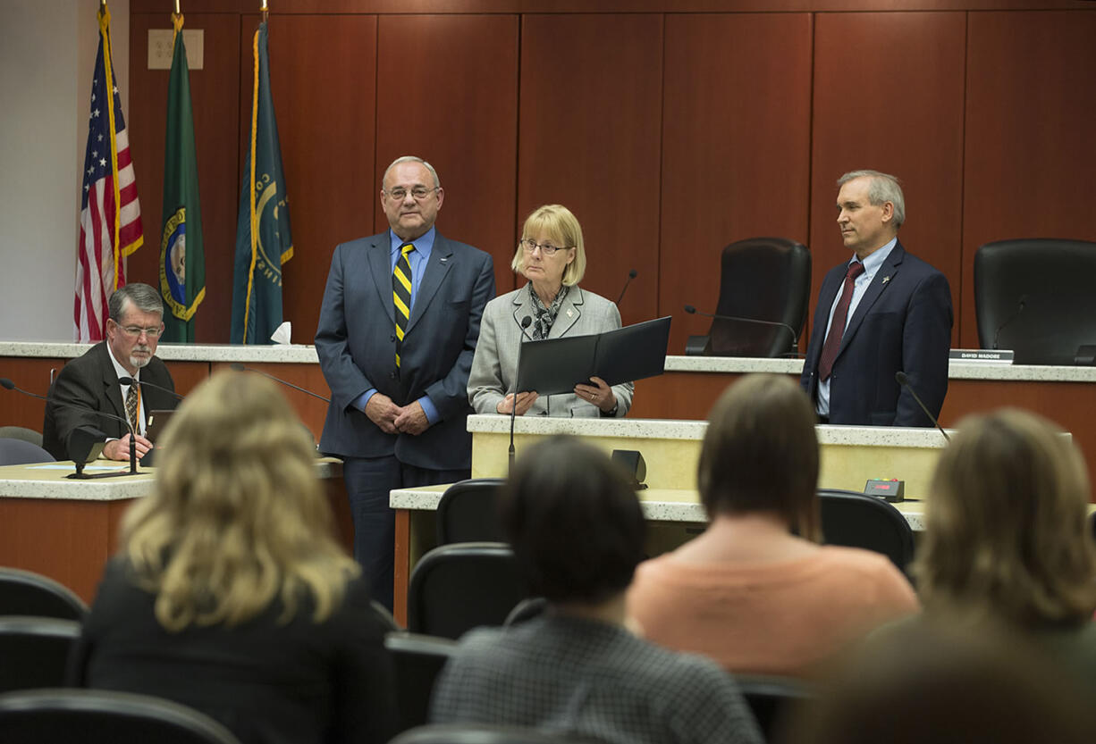 Acting County Manager Mark McCauley, from left, listens as Clark County Councilors Tom Mielke, Jeanne Stewart and David Madore OK a proclamation Tuesday at the Public Service Center.