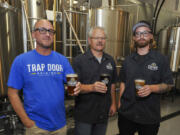 Bree Boothe, left, and Brian Boothe enjoy last Saturday&#039;s grand opening of the Trap Door Brewing at 2315 Main Street in Vancouver.  A craft beer enthusiast this month will launch a Brewcouver Passport program that will showcase 10 local breweries to out-of-towners and local residents.