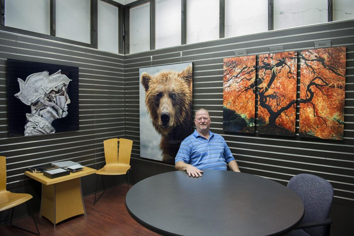 Randy Hopfer, owner of HD Aluminum Prints, is pictured with aluminum prints at his shop Thursday.