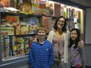 Washougal: Julie Bristol, Gause Elementary School social worker, stands with student helpers Jackson Rauch, left, and Milan Shirakawa in front of food donated to the Weekend Backpack Program.