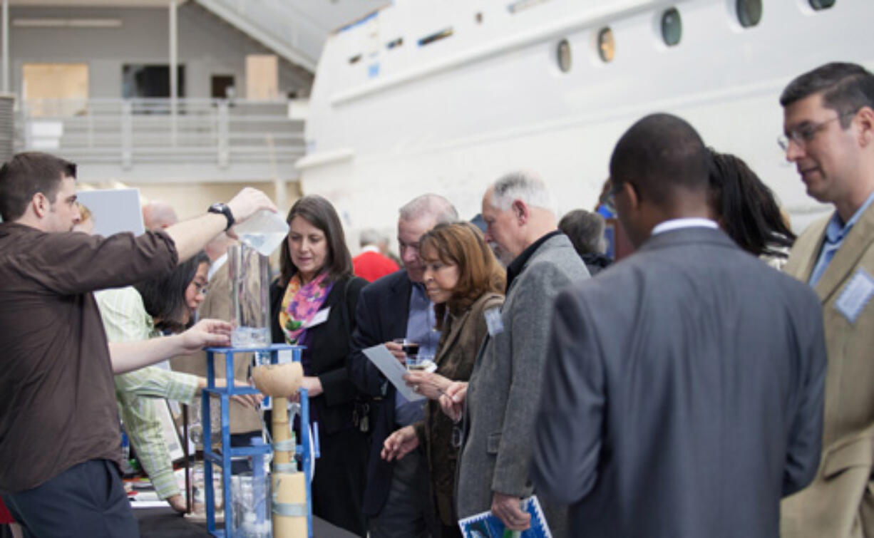 Columbia Way: Clark College engineering student Jesse Bosdell demonstrates a water clock at a Clark College Foundation event on March 15 at Christensen Shipyards.