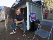 Lloyd Dodge sits in his hut Tuesday at a homeless camp near Share House in downtown Vancouver.