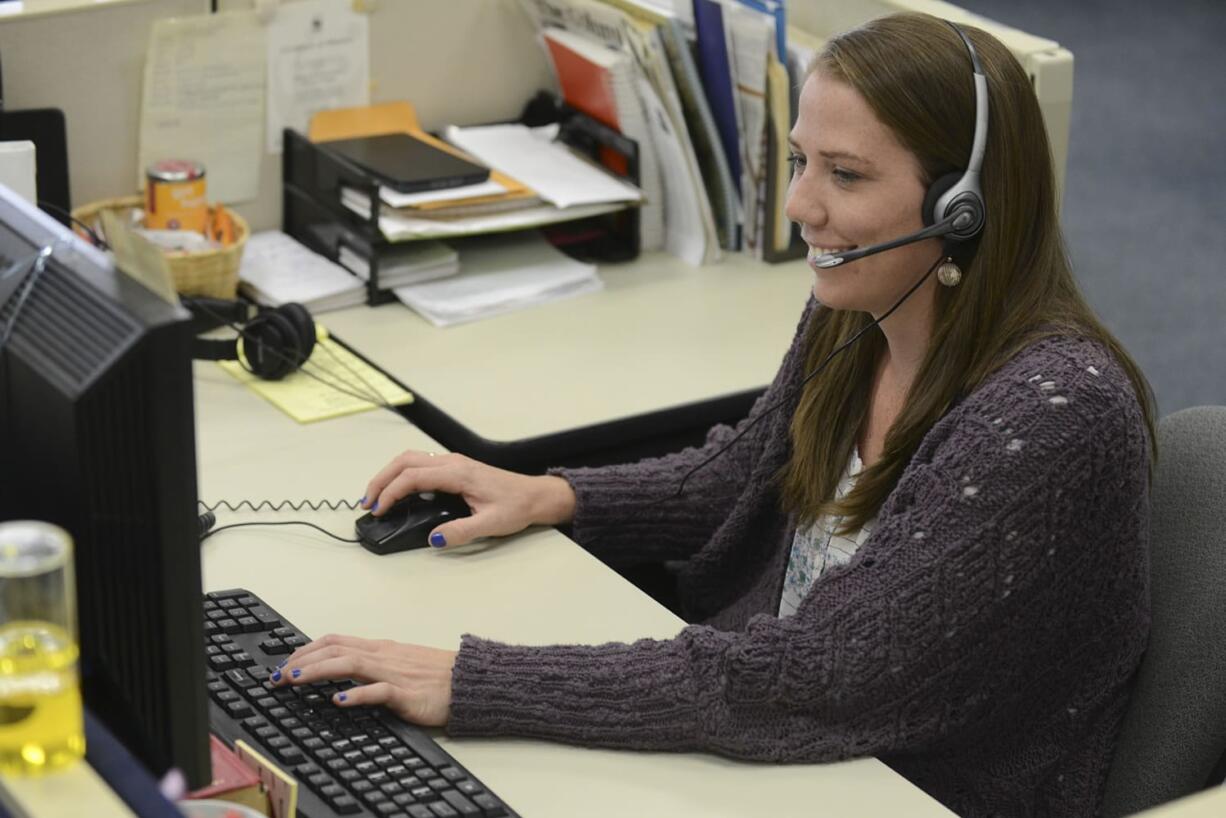 Breaking news reporter Emily Gillespie takes a call at her desk. Her priority is online news.