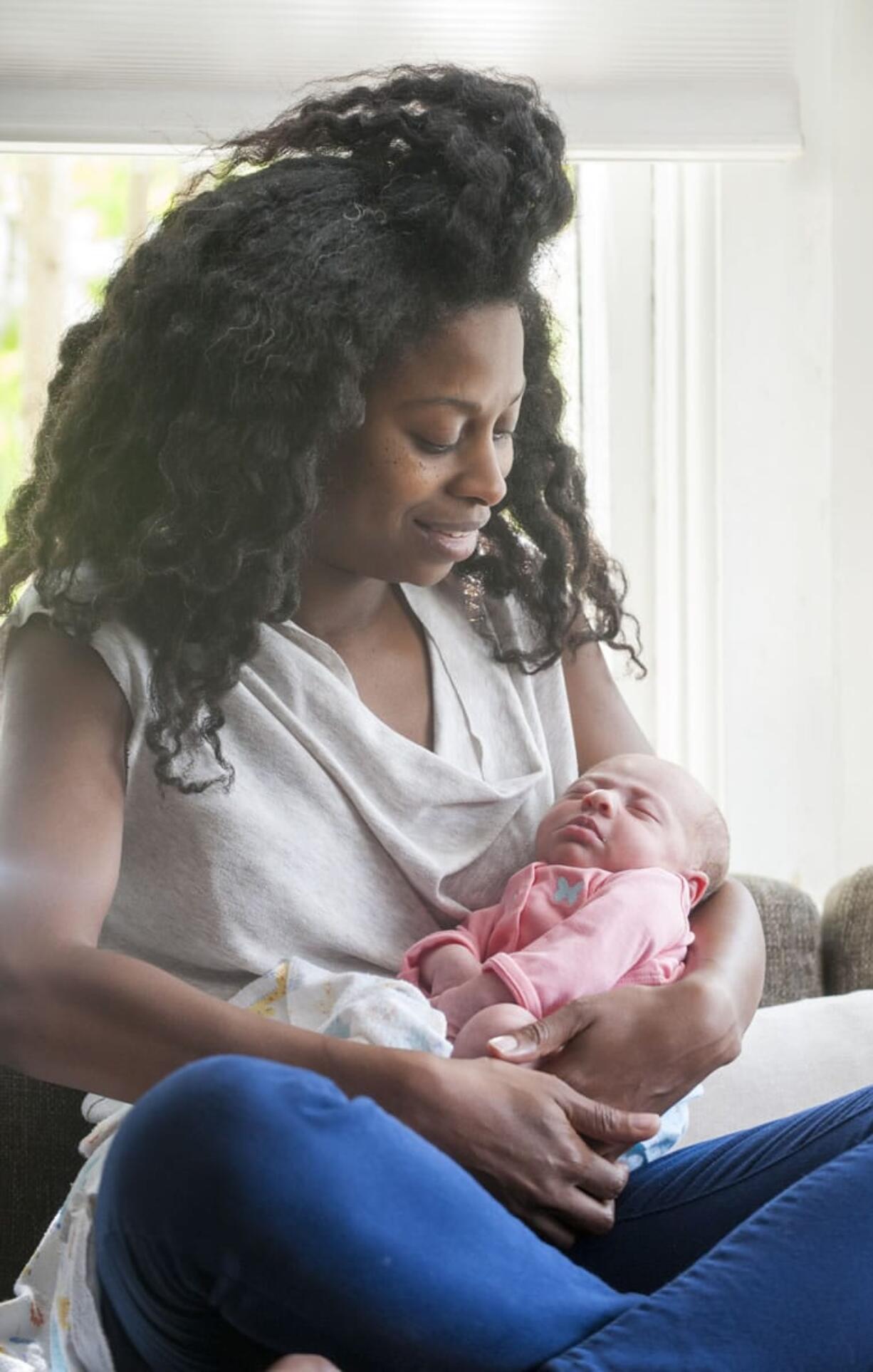 Breast cancer survivor Krystal Fleeger, 39, holds her daughter, Neva, in their Portland home. Neva was born Aug. 2 -- 18 months after Fleeger was diagnosed with breast cancer.