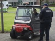 Unarmed security guards Benedetto Vesperini, in the golf cart, and Damon Grady patrol the Clark College campus in December.