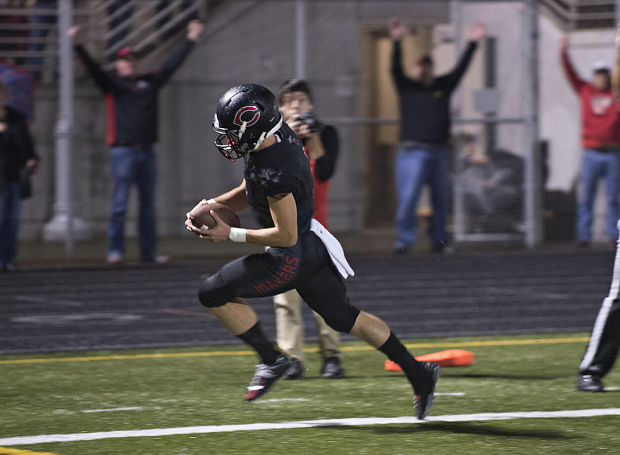 Camas' Jared Bentley scrambles past the defense to score a touchdown in the second quarter Friday night, Oct. 9, 2015 at Doc Harris Stadium.