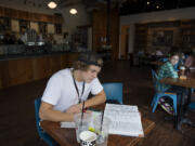 Igor Shapoval, a nursing student at Clark College, works on homework Friday afternoon at Black Rock Coffee in downtown Vancouver.