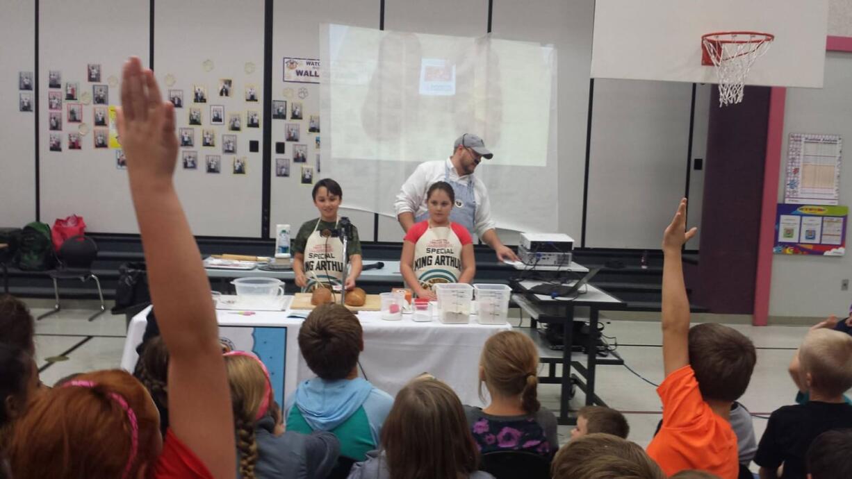 Battle Ground: Captain Strong Primary fourth-graders baked bread at home to donate to shelters after a display from King Arthur Flour, featuring students Oliver Cristaudo and Kallie Carrigan.