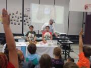 Battle Ground: Captain Strong Primary fourth-graders baked bread at home to donate to shelters after a display from King Arthur Flour, featuring students Oliver Cristaudo and Kallie Carrigan.