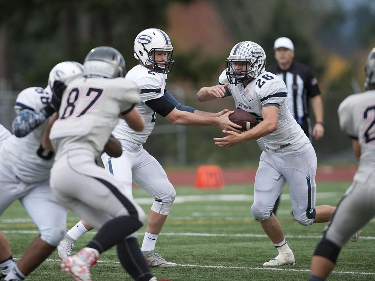 Skyview quarterback Brody Barnum (2) hands off to teammate Blake Ingram (26) in the first quarter Friday afternoon, Oct. 30, 2015 at McKenzie Stadium.