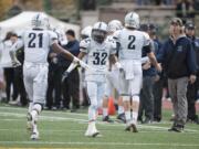 Skyview's Jeremiah Wright (21) celebrates his second quarter touchdown with teammate Tavis Chunphakvenn-Pinkney (32) on Friday. Skyview, Battle Ground and Mountain View will play a tiebreaker Monday to decide two postseason berths.