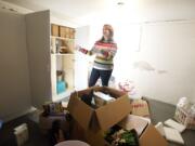 Professional organizer Megan Vaughn opens a cupboard in her basement catch-all room to reveal three punch bowls. &quot;Who needs three punch bowls?&quot; she asked.