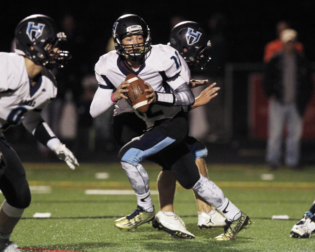 Hockinson quarterback Canon Racanelli drops back to pass against Ridgefield high school.