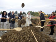 Archbishop of Seattle J. Peter Sartain, center, helps shovel dirt at a blessing and groundbreaking ceremony Saturday on the future site of Seton Catholic College Preparatory High School in Vancouver. The new building is scheduled to open for next school year in September.