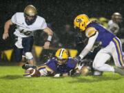 Columbia River&#039;s Hunter Pearson, right, closes in for a fumble recovery after Kelso lost the ball during the second quarter of Friday&#039;s Class 2A Greater St. Helens League game.