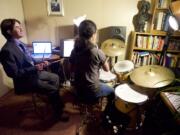 Photos by Steven Lane/The Columbian
Vaughn Brown, left, a deaf-blind percussionist, teaches his student Leilani Towner, seated at the drum kit. After graduating from Washington State School for the Blind, the percussionist graduated from Berklee College of Music in Boston.